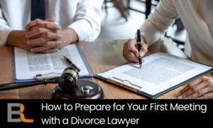 Two people review legal documents during a divorce consultation, with a gavel and clipboard on the table.